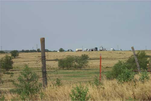 view across fence towards CO2 tanks