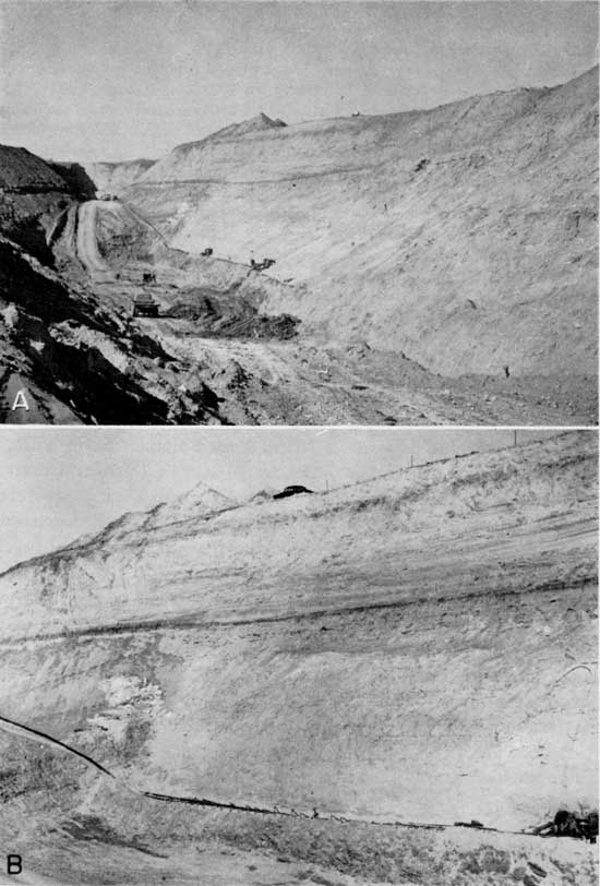 Black and white photos showing large trench dug for dam construction; trucks and a car for scale.