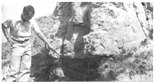 Black and white photo of man pointing at boundary between Cheyenne and Taloga.
