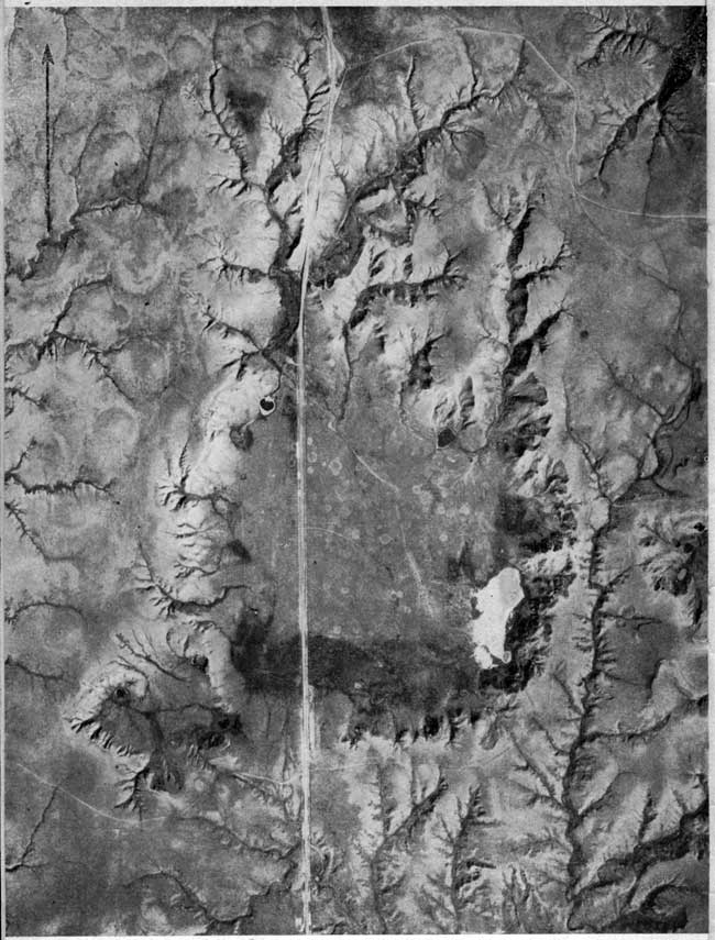 Black and white aerial photo showing depression and drainage pattern.