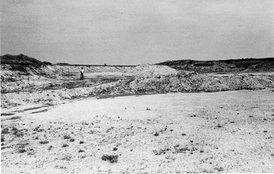 Black and white photo of gravel quarry with exposures of Fort Hays Limestone Member of the Niobrara Chalk.