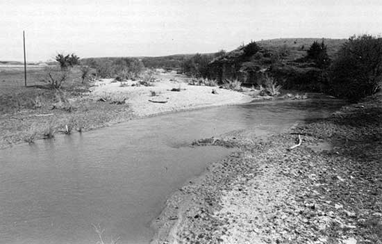 Black and white closeup photo of Saline River showing channel and low terraces.