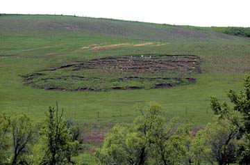 Photo of earth flow--circular flow broken up into horizontal pieces.