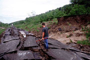 Photo of road destroyed by landslide.