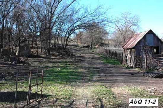 photo of dirt road going past ld farm shed; blocks in trees on left