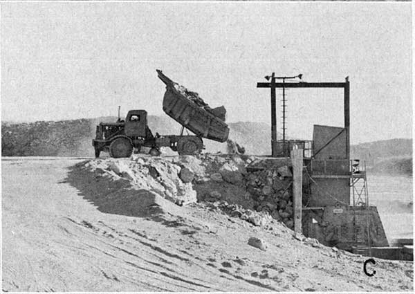 Black and white photo of truck dumping load.