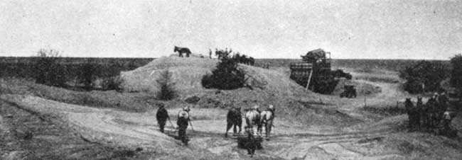 Black and white photo of small sand and grave pit; being mined by men and horse-drawn equipment.
