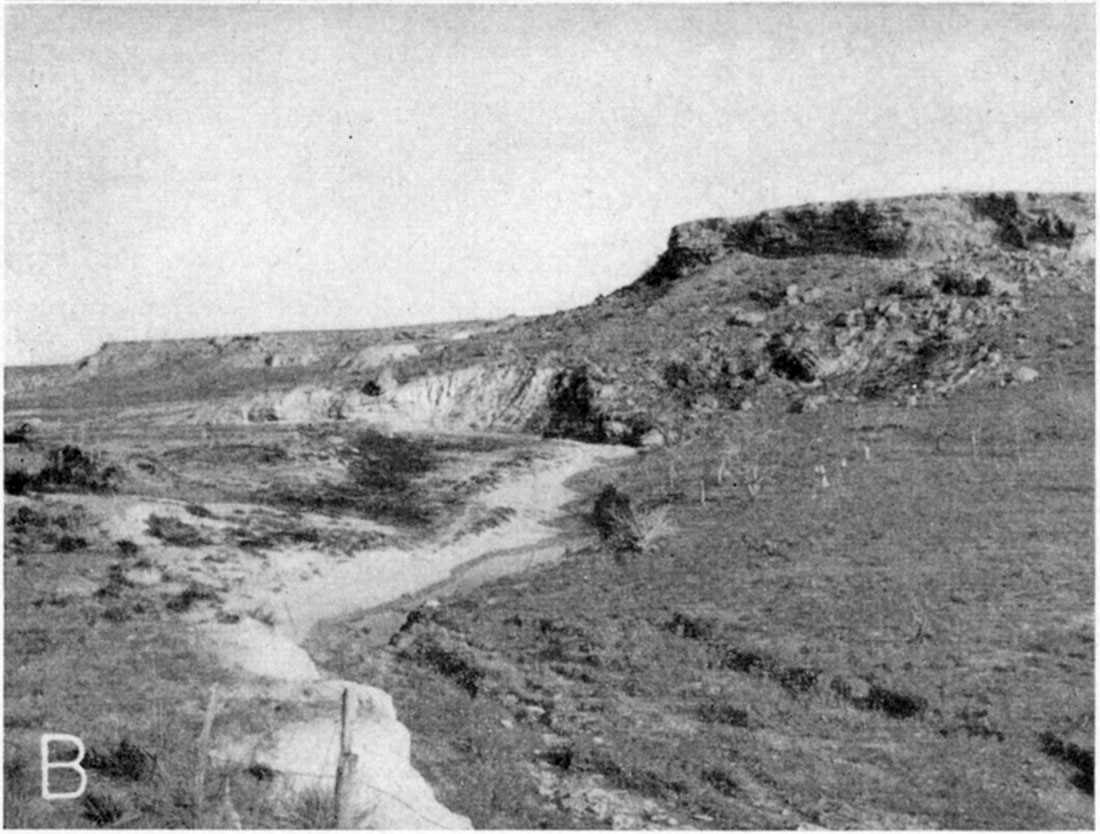 Black and white photo shows stream moving past chalk slope capped with Ogallala.