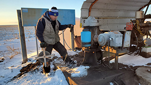 Rick Miller measuring water levels