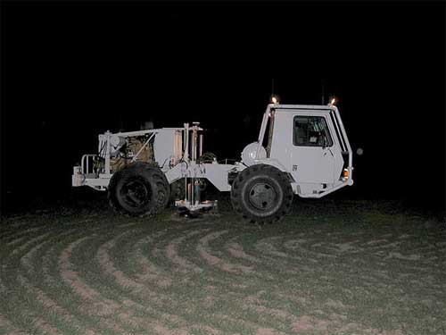 White seismic source vehicle in dark