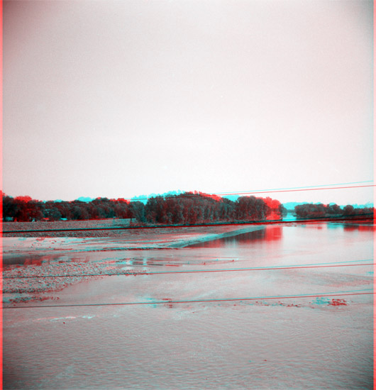 wide shallow river, trees on far bank in front of levee