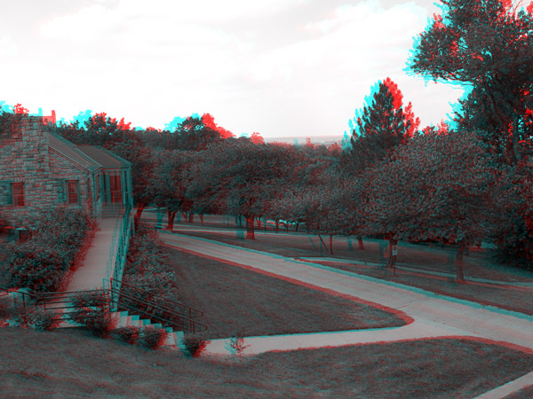 porch of chancellor' residence in foreground; trees and Oread Neighborhood, Lawrence, in background