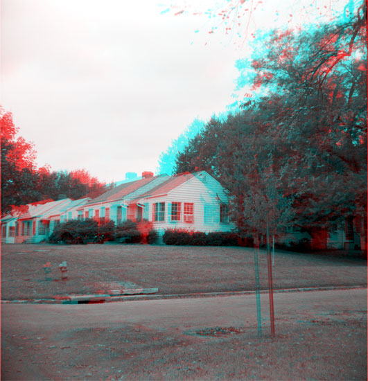 single story white duplex; trees behind