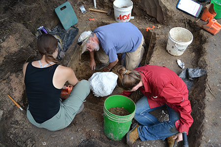 Odyssey crewmembers Chris Hord, Laura Kirsche and Krissy Zuchowski prepare to remove casted bison bones from a test unit at Pipe Creek.