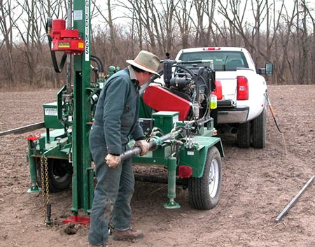 coring rig on trailer behind pickup.