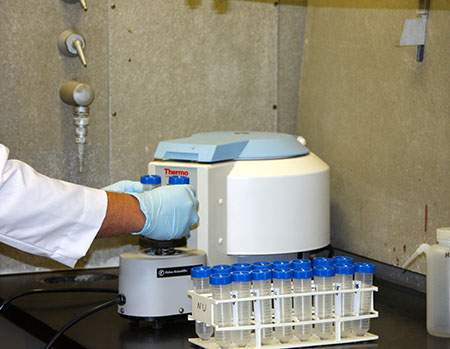 Researcher preparing carbon isotope samples.