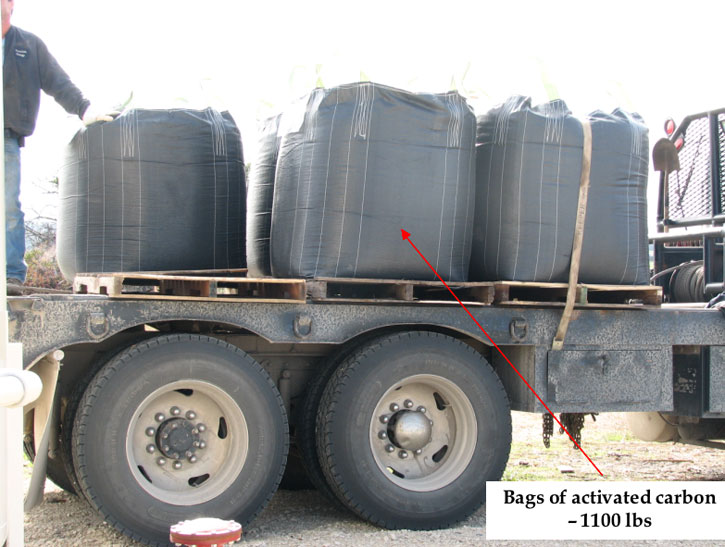 Flatbed truck containing several bags of carbon; each bag weighs 1,100 pounds.