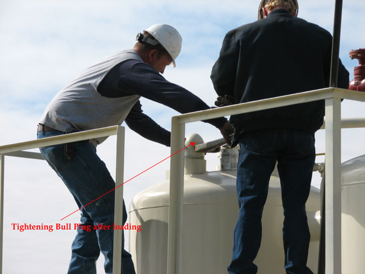 Large wrench being used to tighten plug; system alternates between being under pressure and under vacuum during processing.