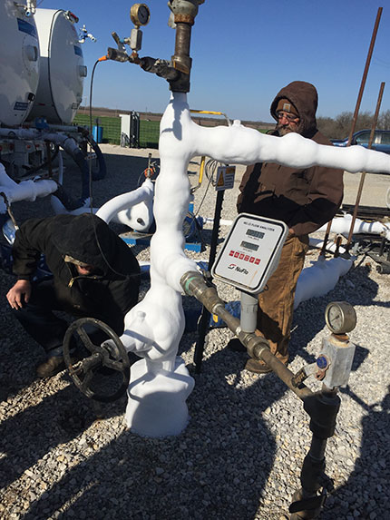 Inspecting the CO2 lines at the KGS 2-32 injection well site.