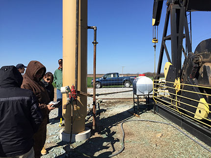 Field crew taking readings for CO2 percent composition of vented gas at Wellington Unit #61.
