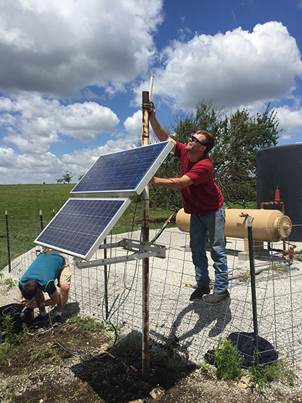 Berexco crew assisting with the installation of the GPS and solar panel to power the station in a remote area in Cowley County.