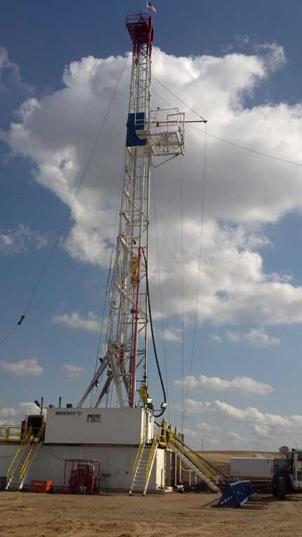 photo of drill rig, bright blue sky