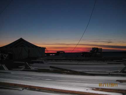 View of tent and well site in twilight.