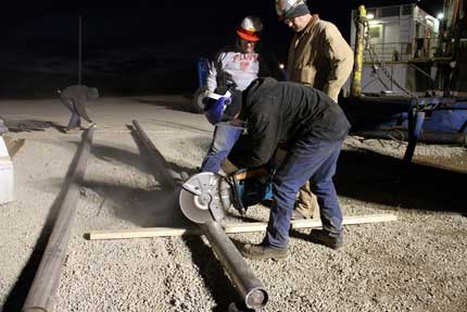 Cutting core barrels to length for shipping and storage.