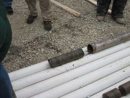 Field trip visitors looking at core.