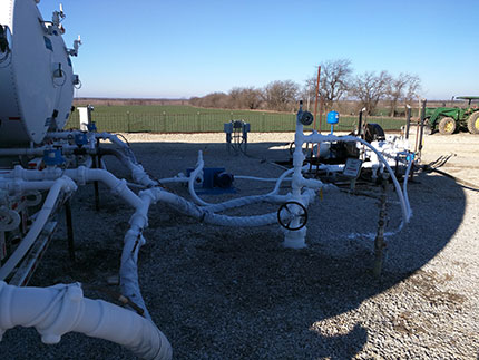 Another view of setup. At wellhead, the master shutoff valve, white CO2 line at top right, high pressure ball valve if need to hook a truck up.