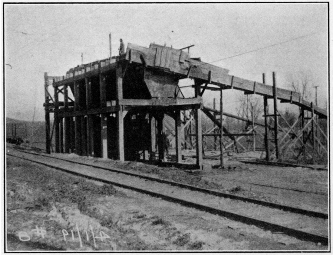 Black and white photo of sand loading bins on the Kansas river.