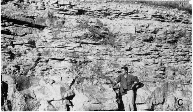 Black and white photo of man standing next to Burr, Salem Point, and Neva members.