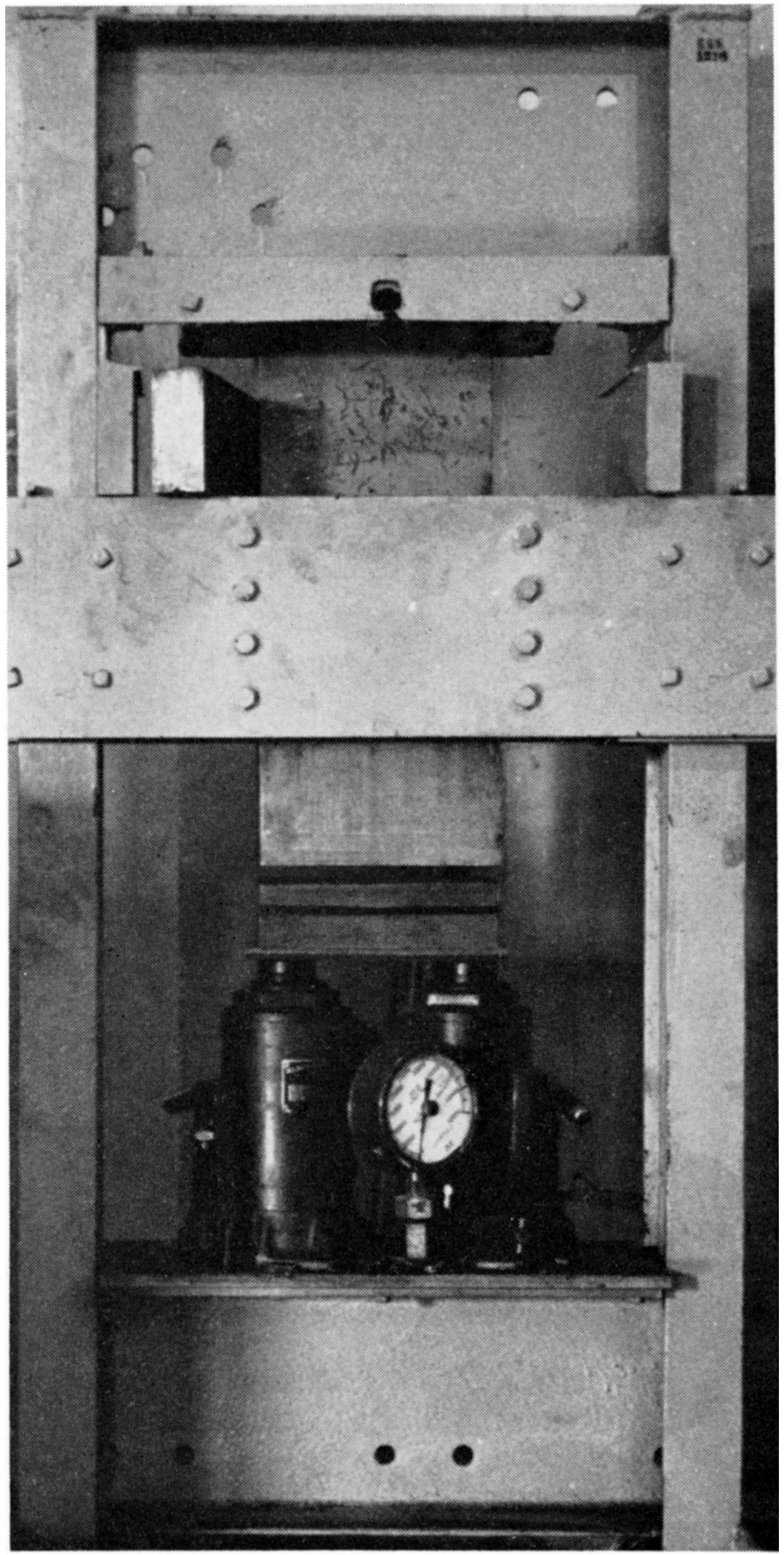 Black and white photo of press for dry-pressing refractory bricks.