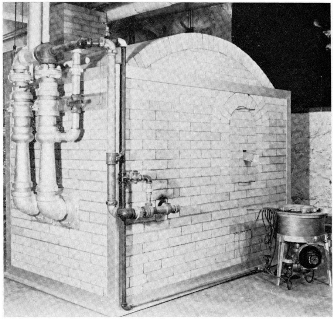 Black and white photo of gas-fired down-draft kiln. PCE furnace at right.