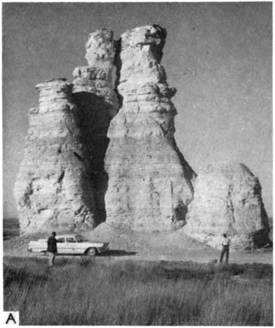 Black and white photo of Castle Rock, observed by two people.