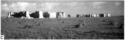 Black and white photo of Monuments Rocks; line of remnants, stretching for perhaps a mile; very steep sides and flat tops; very bright white in color.