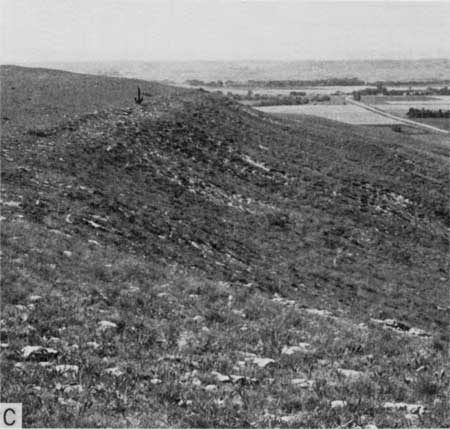 Black and white photo of gentle slope with contact line at top.