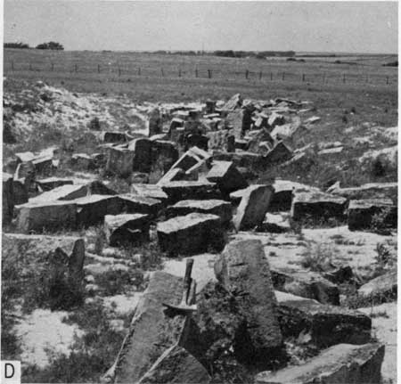Black and white photo of fencepost quarry showing jumble of cut stone.