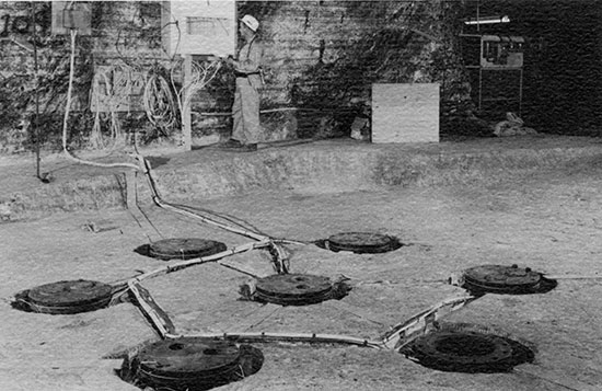 instrumentation embedded in floor of salt mine, wired to instrument panel on far wall