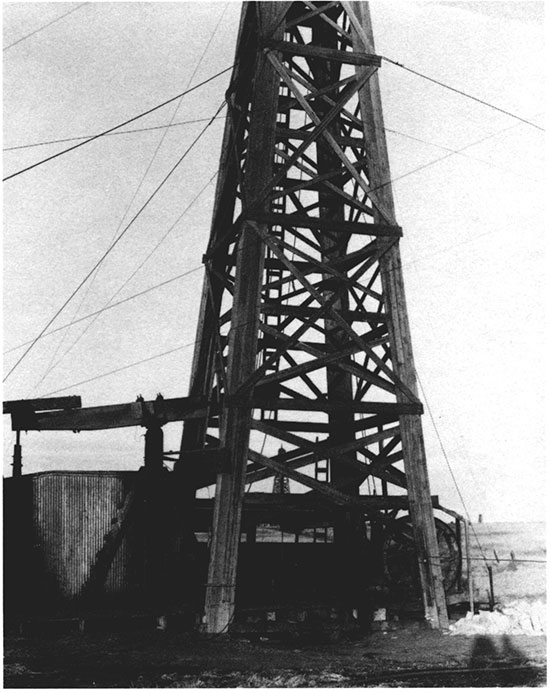 Black and white photo of wooden derrick and cable-tool equipment, 1925.