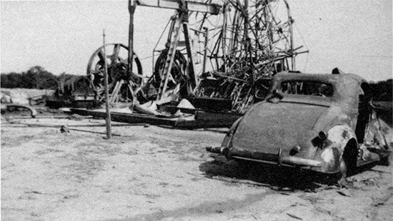Black and white photo of the Marathon (Ohio) Oil Company's J. G. Harbaugh No. 1, June 18, 1936, the morning after the Wednesday night fire.