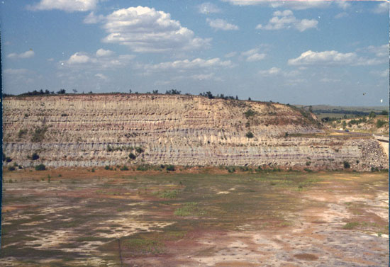 Color photo of hillside next to spillay with Council Grove Group exposed.