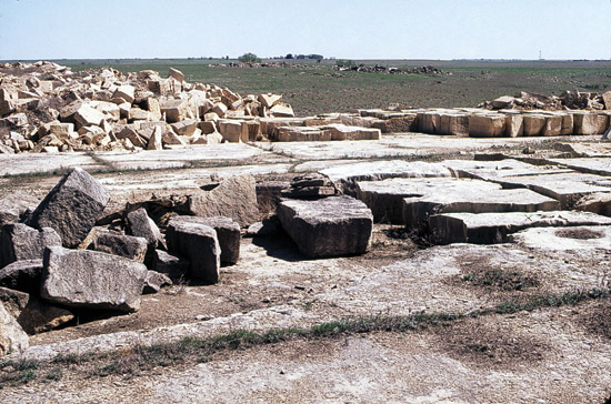 Color photo of limestone quarry; cut blocks awaiting use.