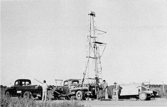 Black and white photo of portable drilling machine.