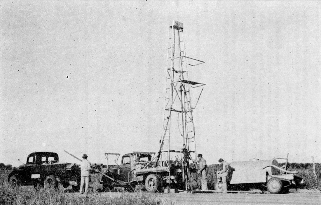 Black and white photo of portable hydraulic-rotary drilling machine owned and operated by the State and Federal Geological Surveys.