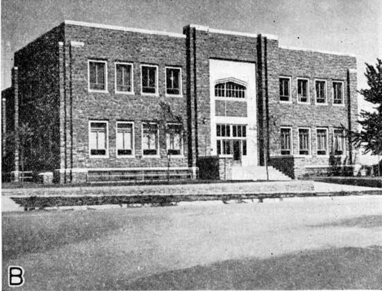 Black and white photo of community building made of Ogallala stone.