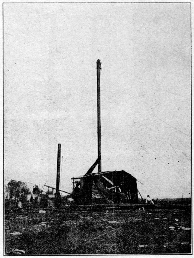 Old black and white photo of drilloing rig.