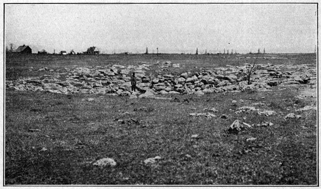 Black and white photo showing sink-hole development in upper division of the Fort Riley limestone.