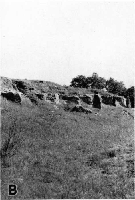 gentle grassy slope leading to outcrop, perhaps 6 feet thick, vertical faces.