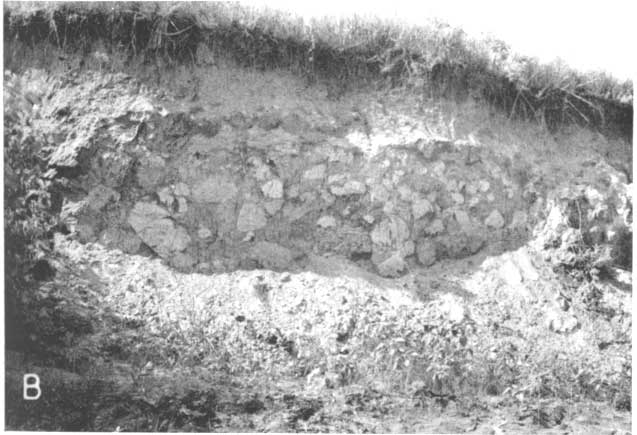 Black and white photo; steeply sided pit; mostly sand and gravel topped with grassland; large (basketball-sized) blocks of volcanic ash; McPherson County.